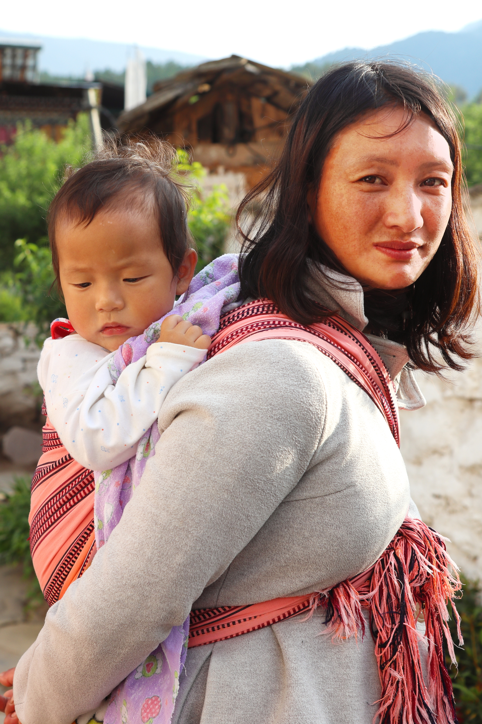 1st image from my "Portrait from Bhutan" series. I took this photo inside Kyichu Lhakhang in Paro. It is a portrait of a mother carrying his son in her back.