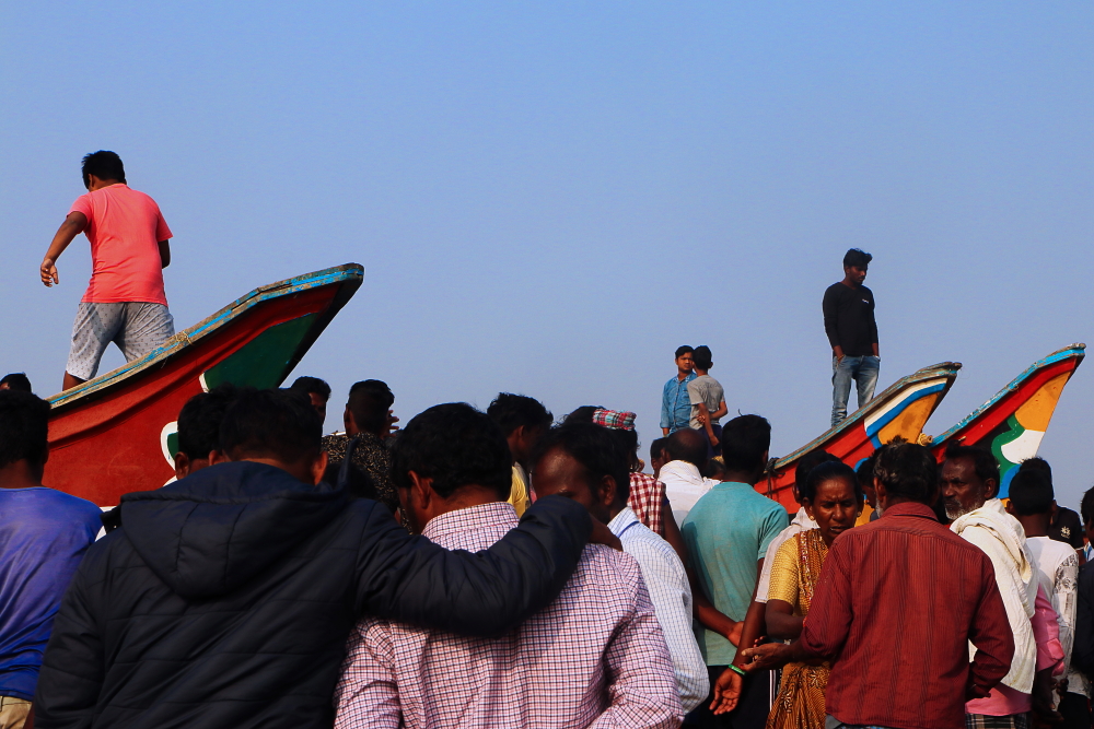 Local crowd waiting for fishing boats in Penthakata sea beach