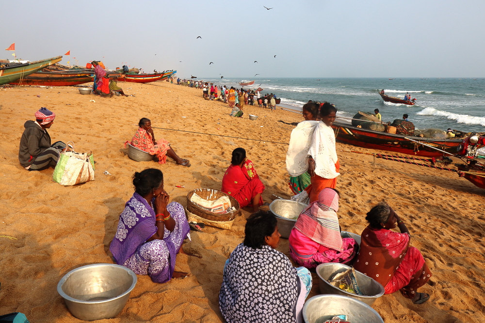 Women waiting for fishing boat to arrive