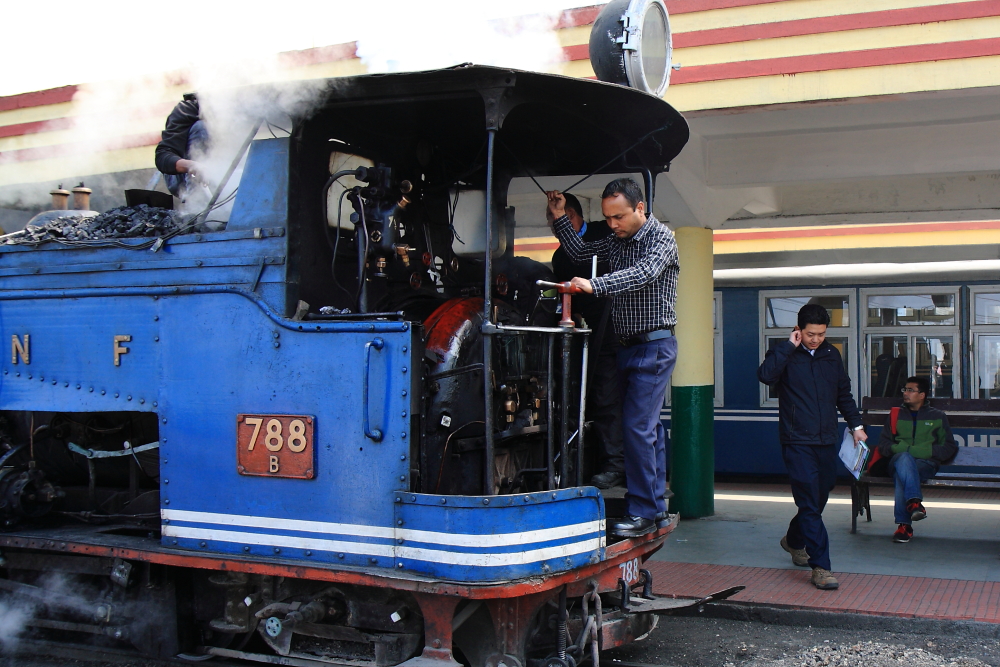 Workers checking a Steam Locomotive before its run from Darjeeling station.