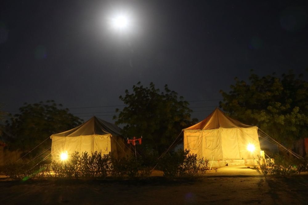 Our tents near Sam sand dunes underneath the moonlit sky.