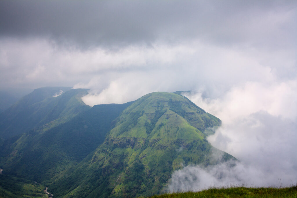 The white layers of monsoon cloud along the ridges of green hills looks enchanting.